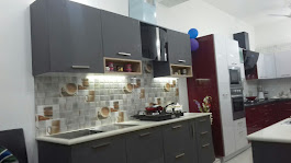 Straight modular kitchen with grey cabinets, designer backsplash tiles, and gas hob